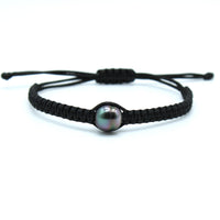a black macrame style bracelet featuring a colorful circle Tahitian black pearl