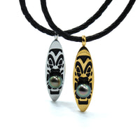 Two necklaces with black cord and decorative pendants featuring tahitian black pearls on a white background