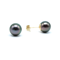 Pair of black pearl earrings on a white background