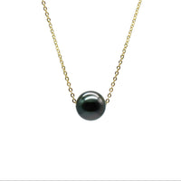 Necklace with a black pearl on a white background
