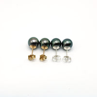 Set of stud pearl earrings on a white background