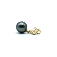 Side view of large gold flower pendant with a Tahitian black pearl with a white background
