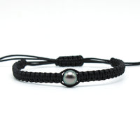 A hand braided macrame style tahitian black pearl bracelet on waxed polyester featuring a lustrous, 9mm, blue/green, tahitian pearl.