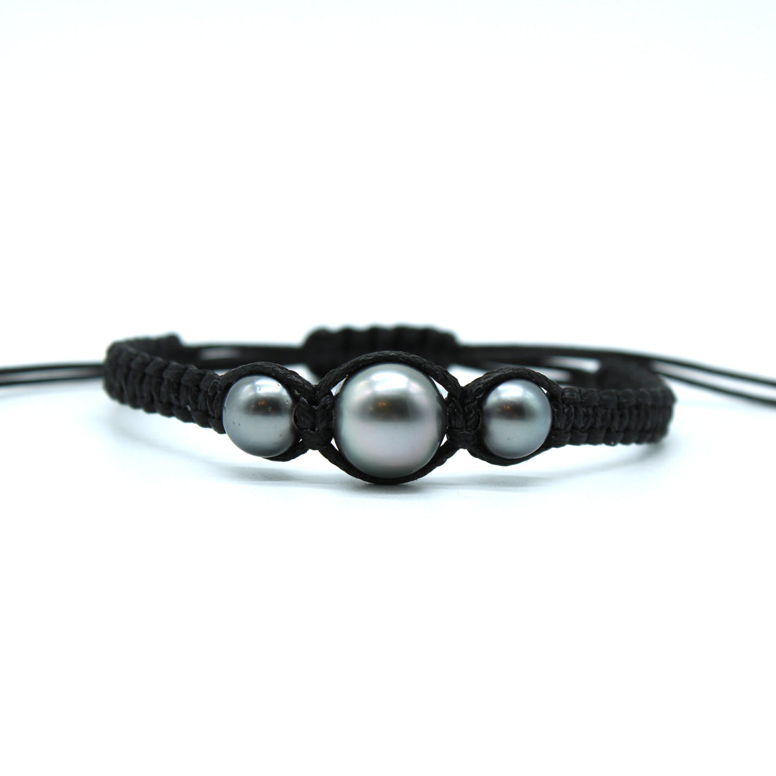 Black macrame bracelet with three pearls on a white background