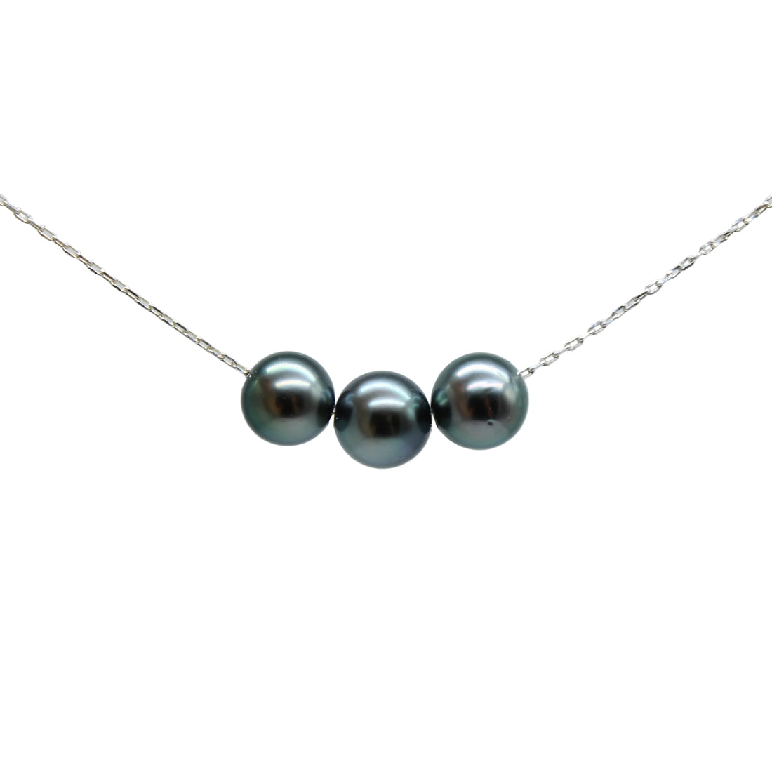 A delicate silver chain necklace featuring three colorful black pearls aligned horizontally in the center, set against a solid light gray background.