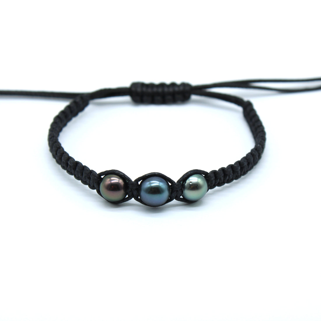 Black braided bracelet with three pearls on a white background