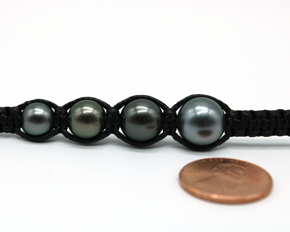 Tahitian pearl size comparison in macrame weave — 8mm, 9mm, 10mm, and 11mm pearls with penny for scale