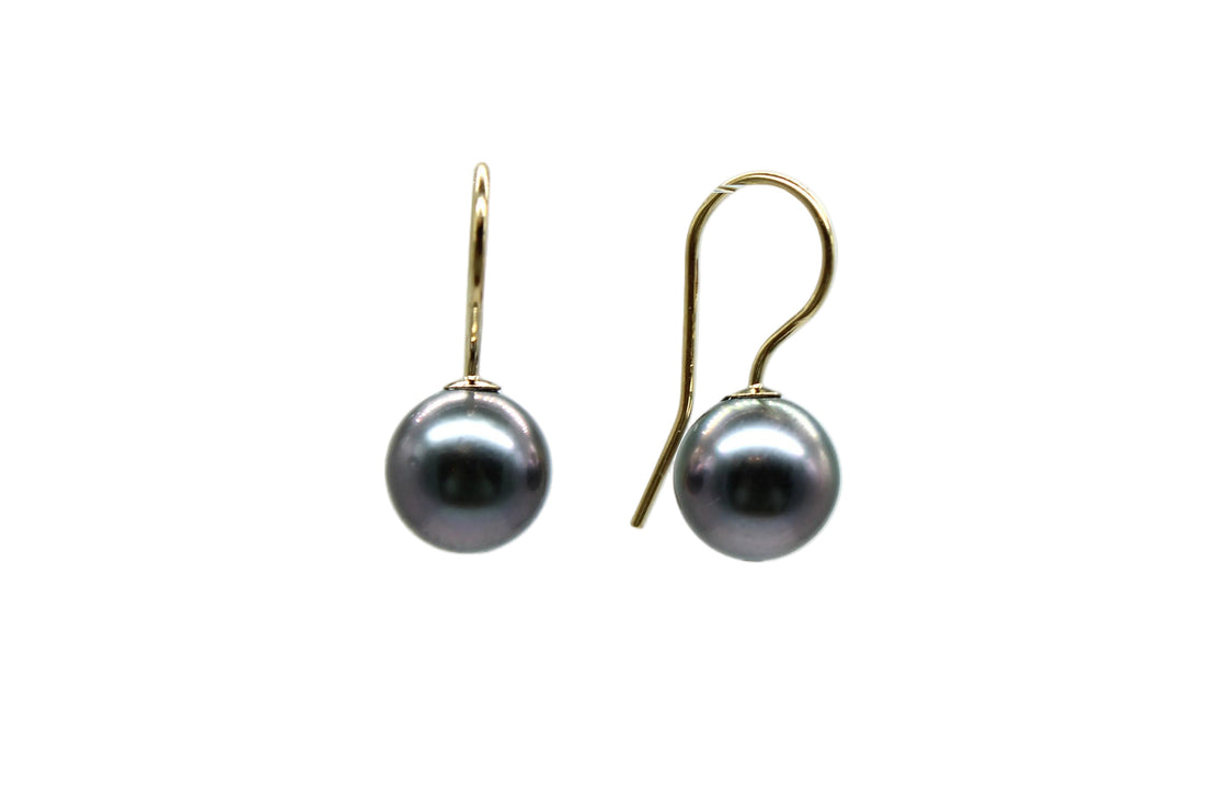 Front and side view of gold filled french hook with Tahitian black pearl earrings with a white background