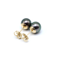 Pair of black pearl earrings with gold posts on a white background