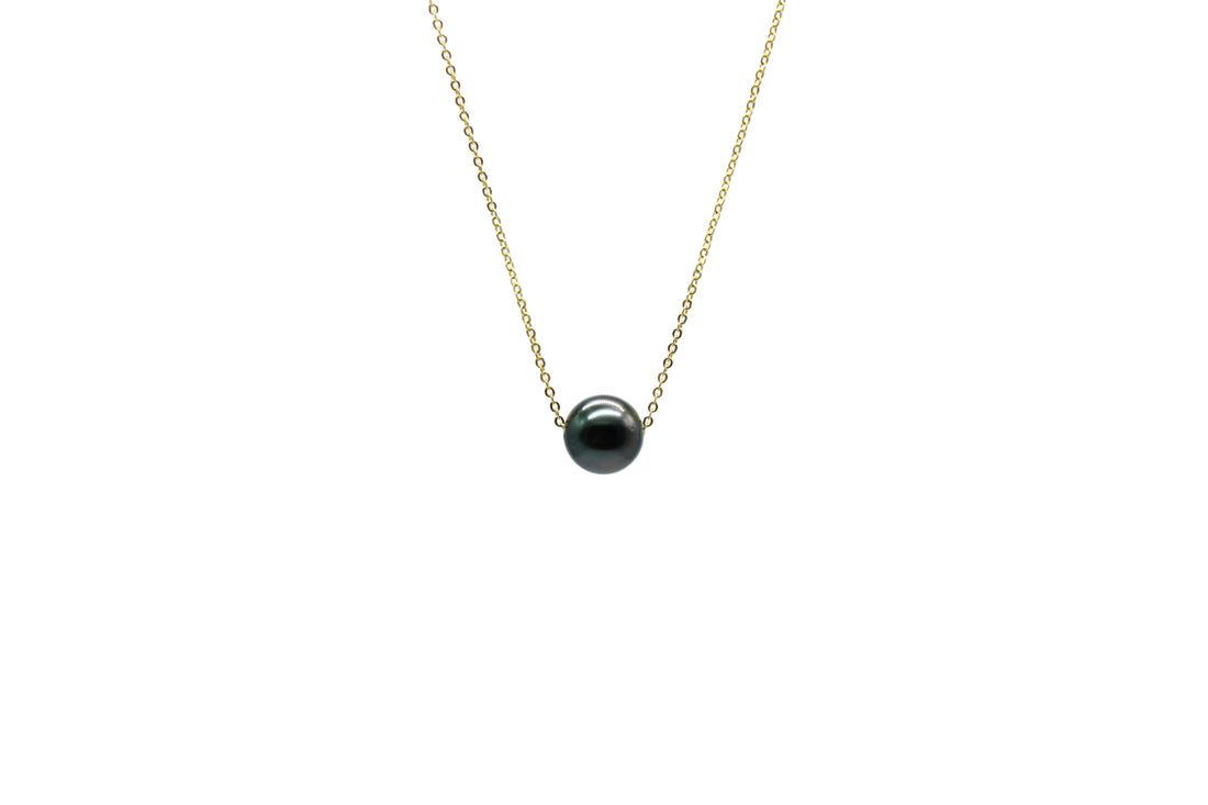 Necklace with a black pearl on a white background