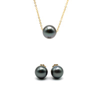 Black pearl necklace and stud earrings on a gold chain against a white background