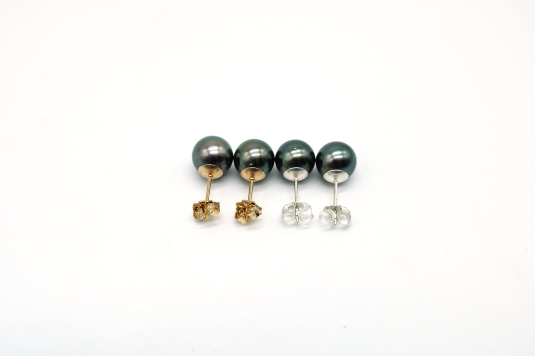 Set of stud pearl earrings on a white background