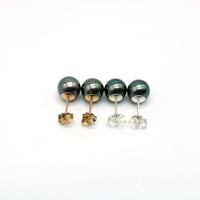 Set of stud pearl earrings on a white background