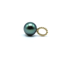 Single pearl on a gold oval pendant against a white background