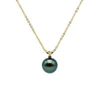 Necklace with a green pearl pendant on a gold chain against a white background