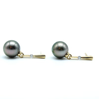 Pair of pearl earrings with gold and lab grown dangly earrings on the side with white background