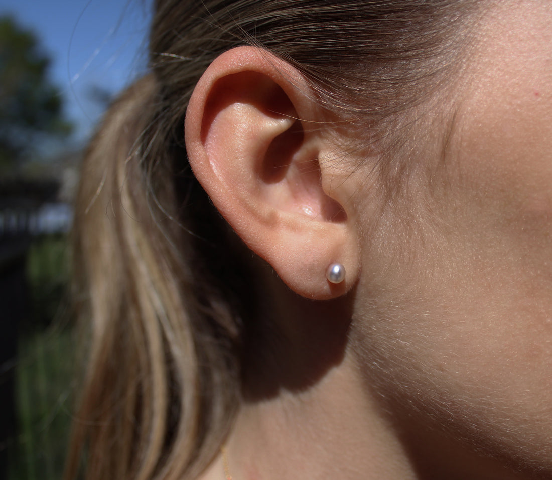 Model wearing keshi pearl stud earrings outdoors