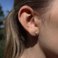 Model wearing keshi pearl stud earrings outdoors