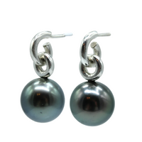 Pair of black pearl earrings with sterling silver hooks on a white background side view