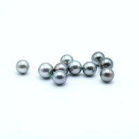 Silver Tahitian black pearls on a white background