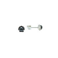 Small black keshi pearl earrings sitting in a shell shaped post with a white background