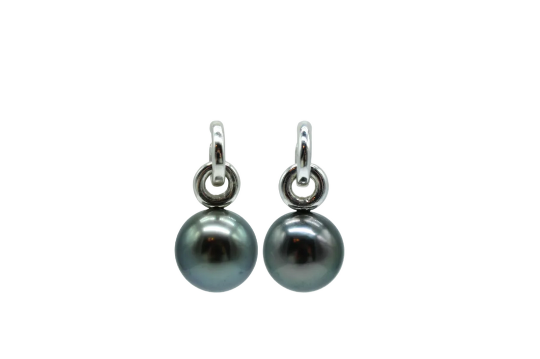 Pair of black pearl earrings with sterling silver hooks on a white background
