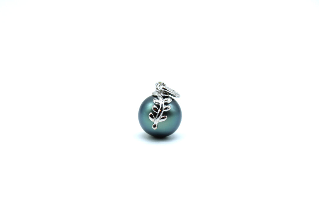 Pearl charm with leaf design on a white background