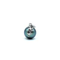 Pearl charm with leaf design on a white background