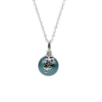 Sterling silver leaf pendant featuring a blue color tahitian black pearl on a necklace on a white background