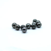 Tahitian Black Pearls on a white surface