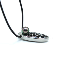 Silver pendant with a black cord and a central pearl on a white background