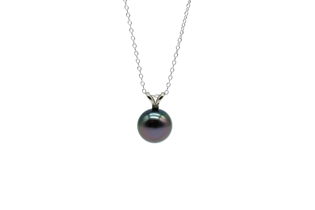 White gold rabbit ear pendant featuring a purple tahitian black pearl on a silver chain with a white background