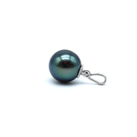 White gold tahitian black pearl pendant laying on its side on a white background
