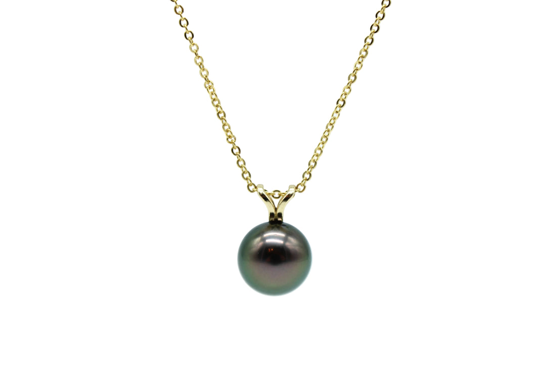 Yellow gold necklace and pendant featuring a black pearl on a white background